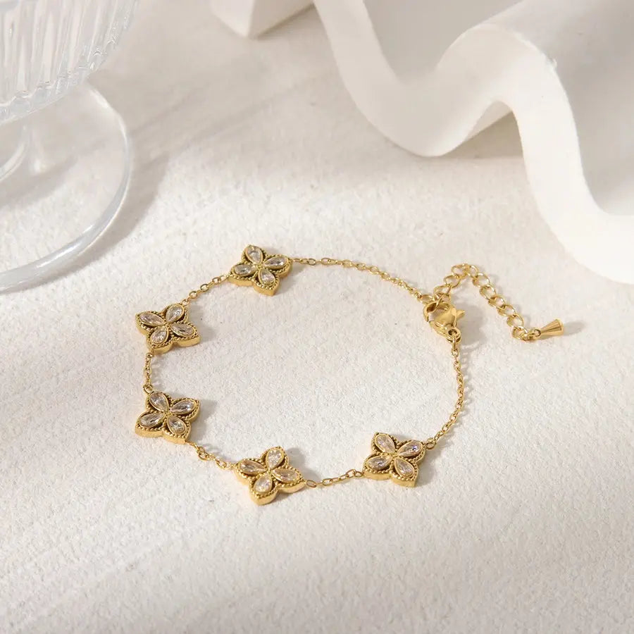 Pulsera de acero inoxidable, bañada en oro de 18K con delicadas flores en circonio o acrilico, un toque de elegancia natural. - Madoma & Co.